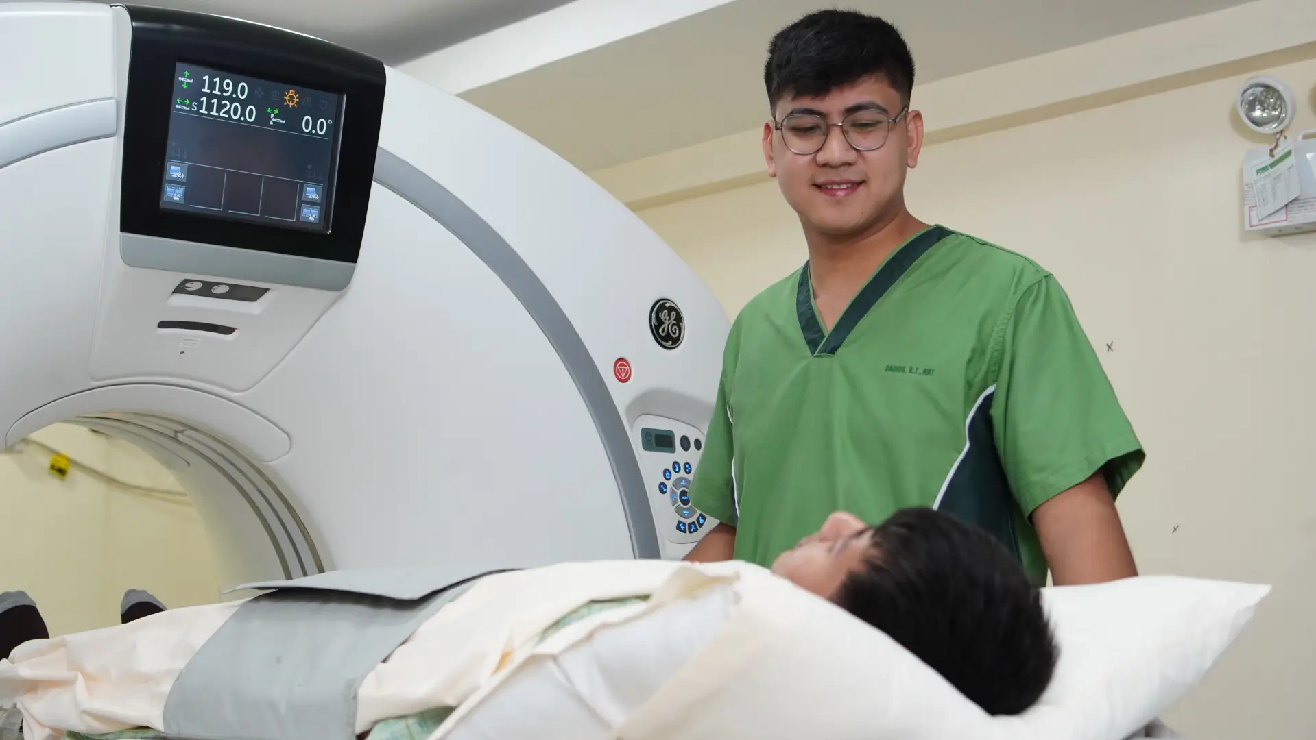 Clinician assisting patient with CT/MRI scan procedure.