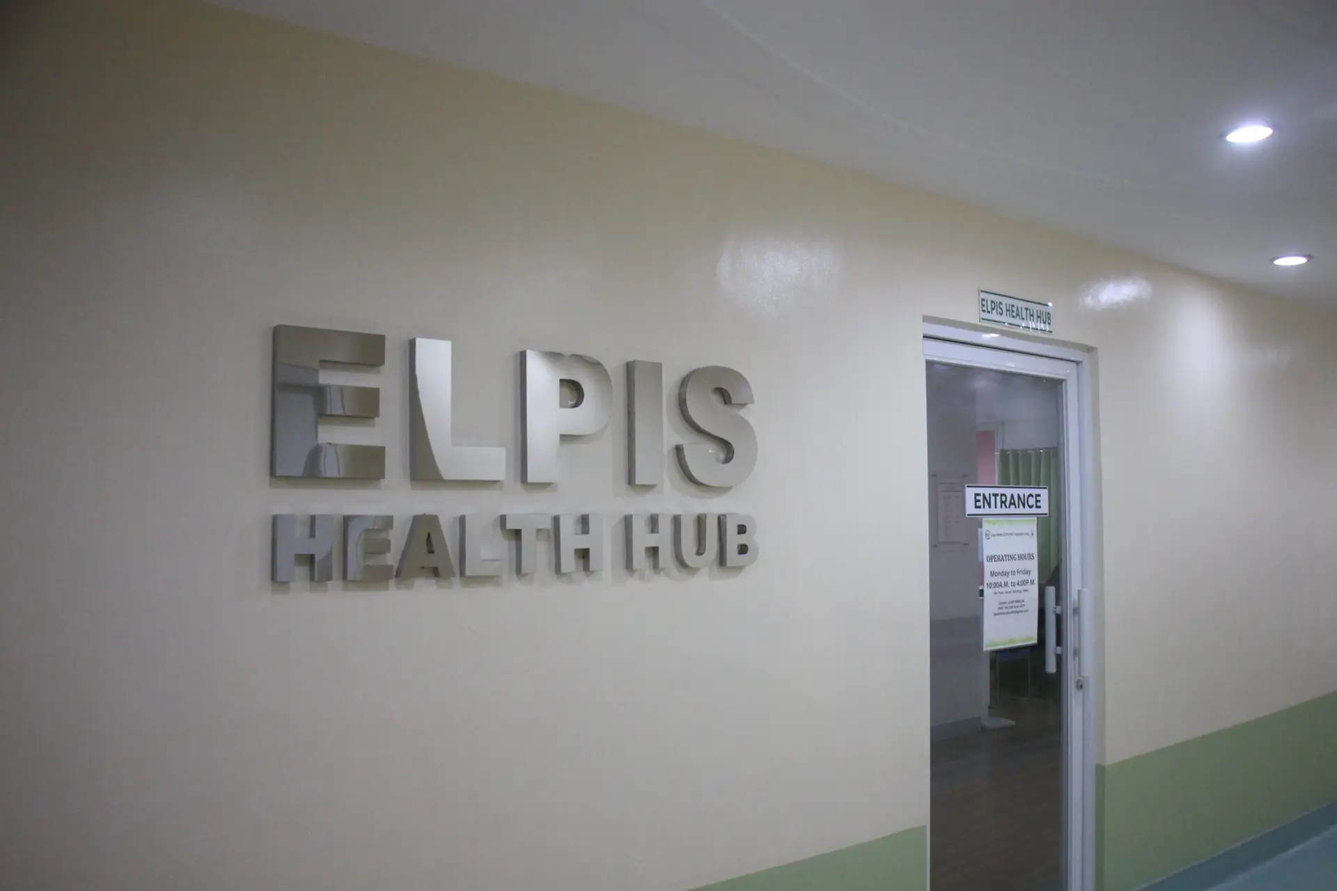 Wall sign reading “ELPIS HEALTH HUB” in hallway.